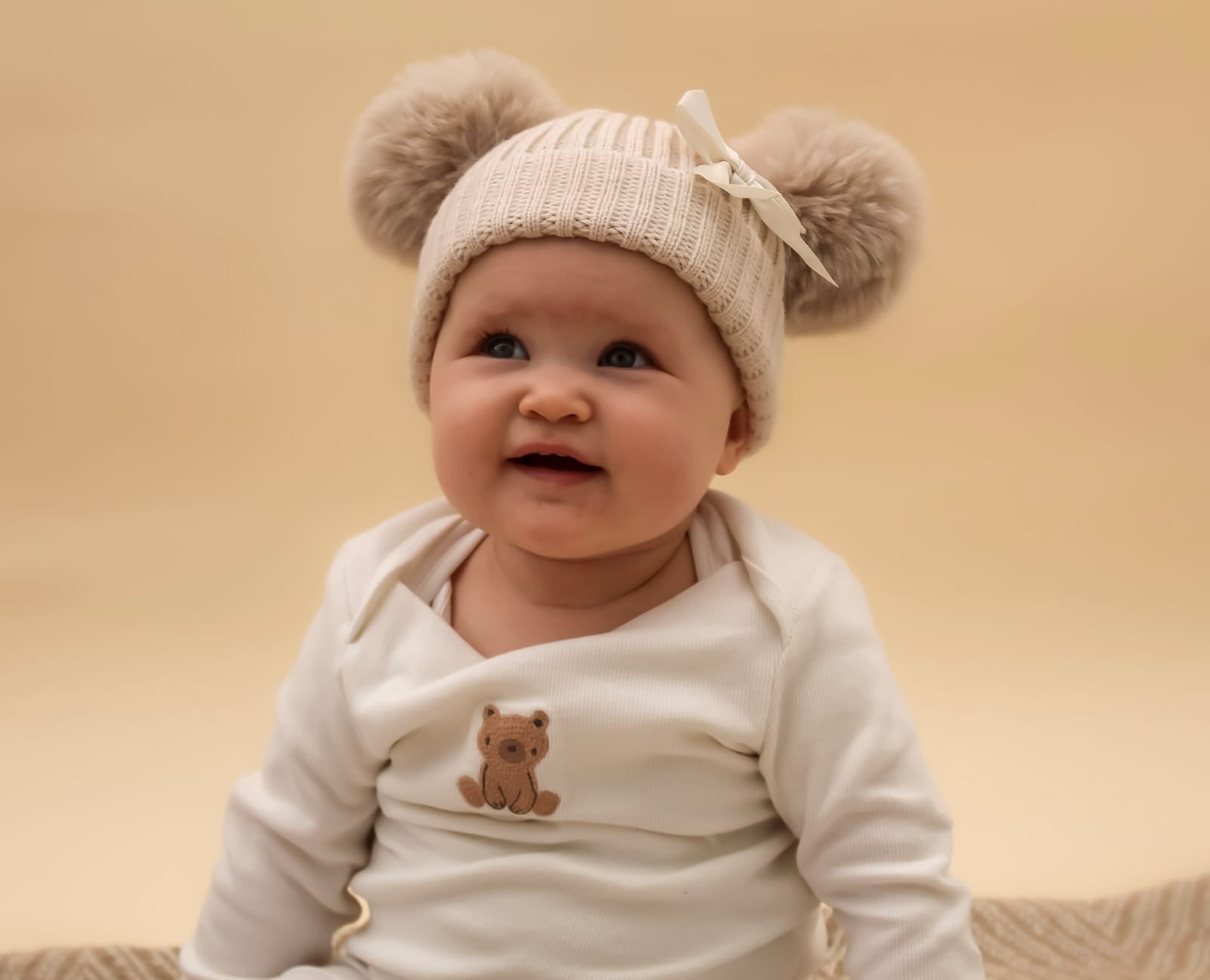 cute knitted cream baby hat with bow