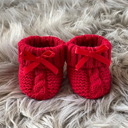 red knitted baby booties with bow