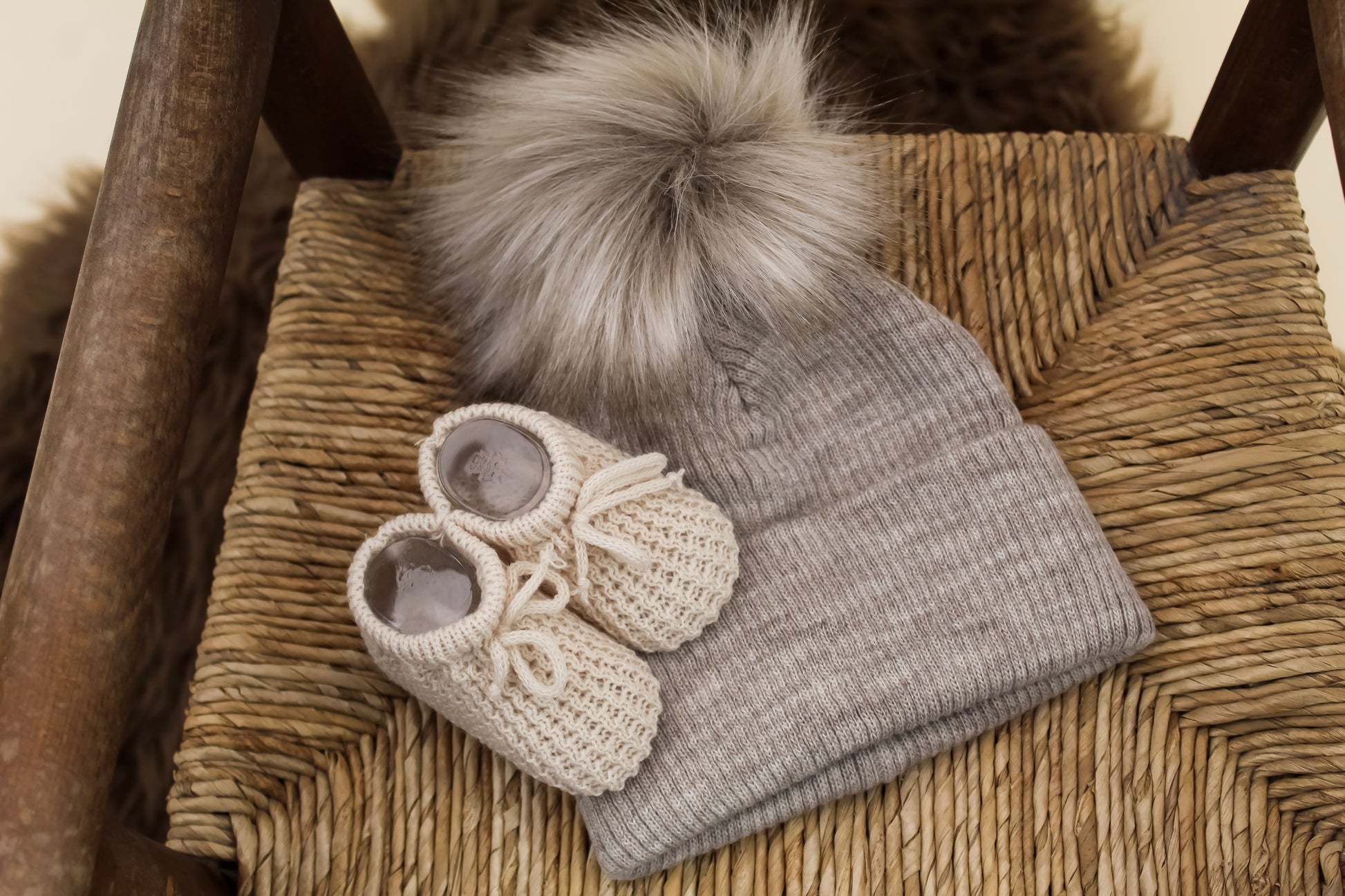 Knitted Taupe Sandy winter baby hat with furry pom pom and neutral knitted baby booties