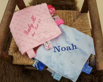 Baby blue and baby pink embroidered baby comforter with labels