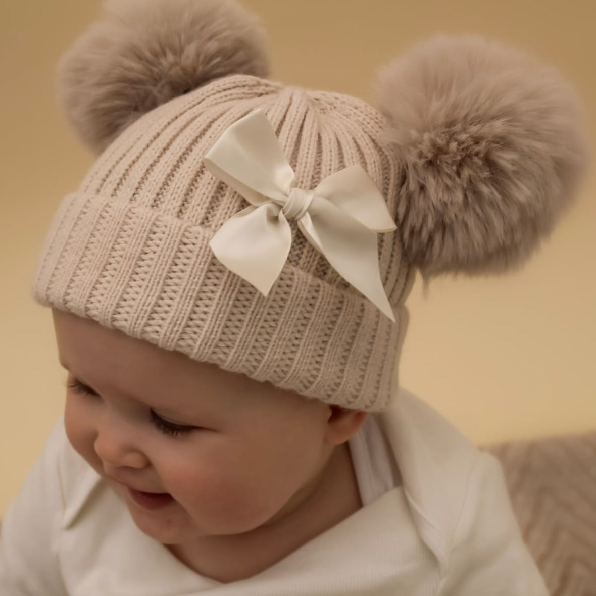 Double pom pom cream knitted bow baby hat