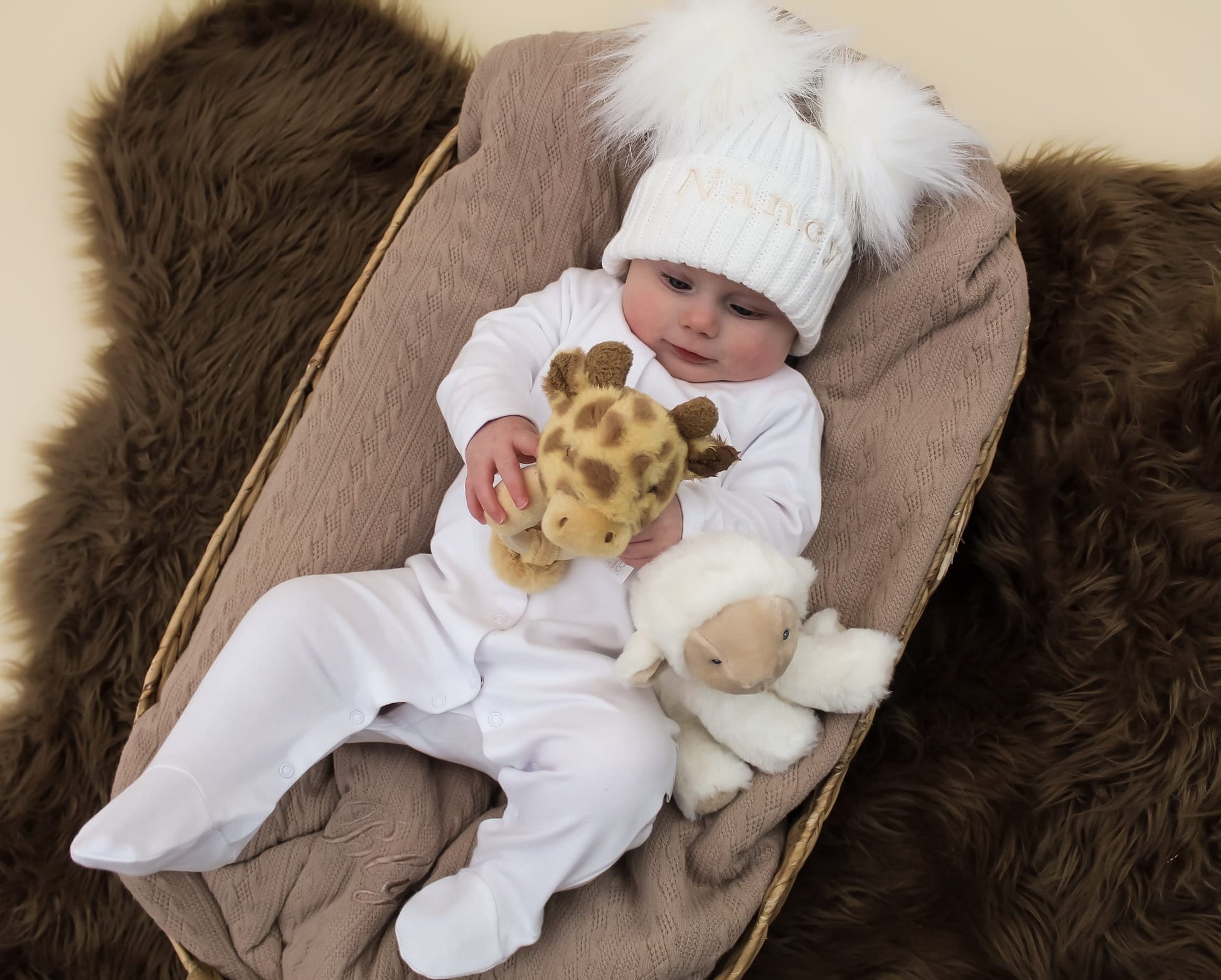 White Newborn baby clothes and giraffe rattle